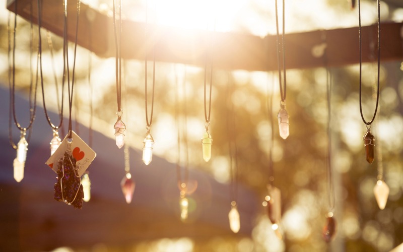 handmade necklaces hanging in the sunlight